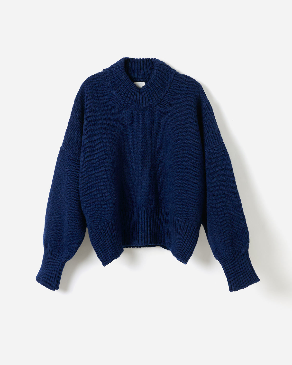 Navy jumper No15 by Babaà worn by a woman, showcasing its relaxed fit and soft knit fabric in a stylish silhouette.