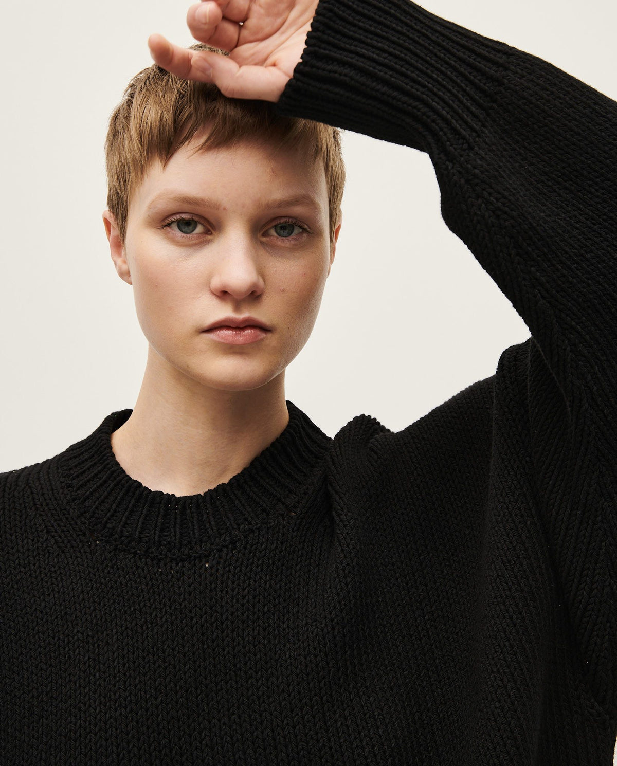 Black Babaà No16 jumper worn by a woman, featuring a cozy, stylish knit design suitable for casual or smart-casual wear.
