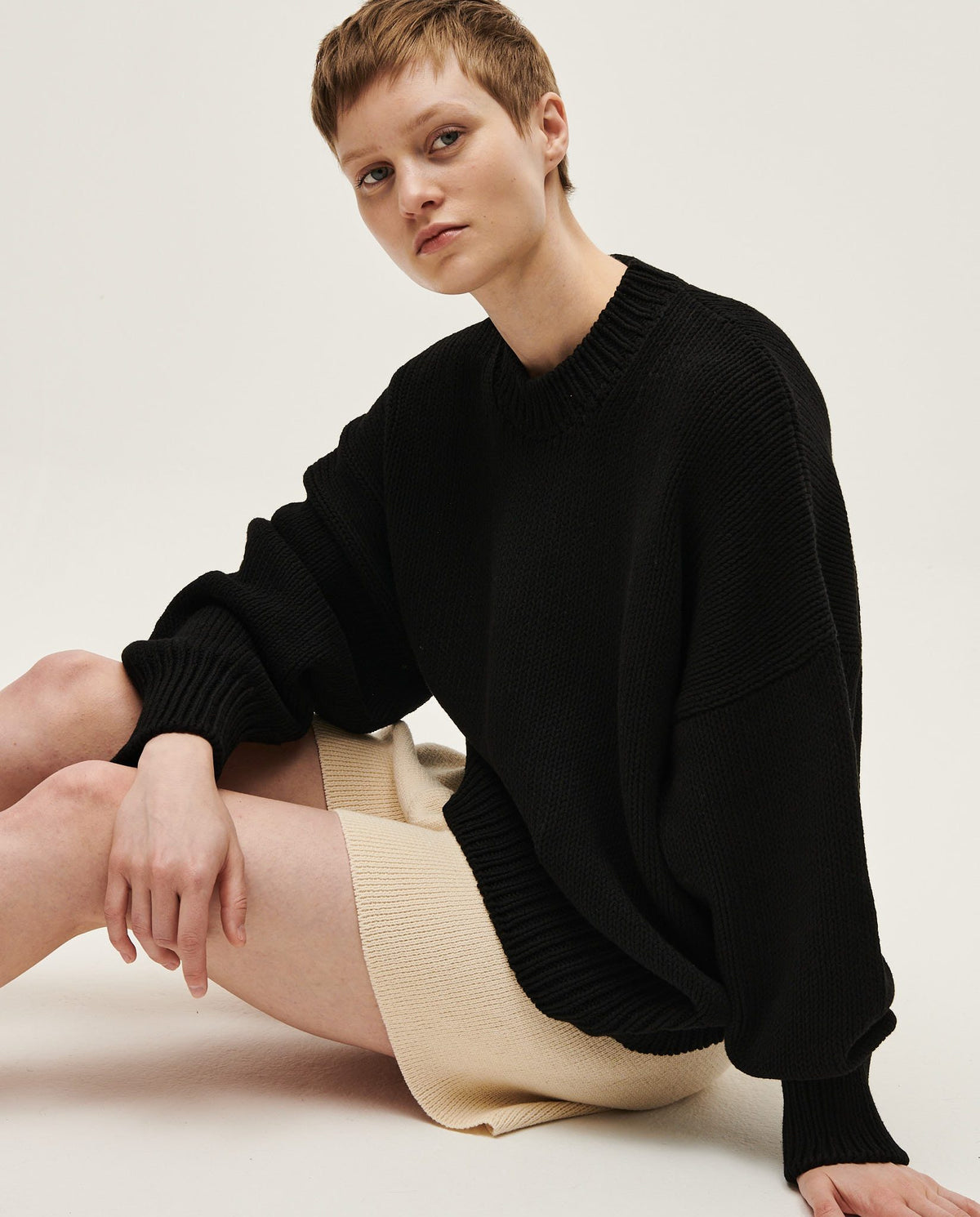 Black Babaà jumper No16 worn by a woman, featuring a cozy, stylish knit design suitable for casual or elegant looks.