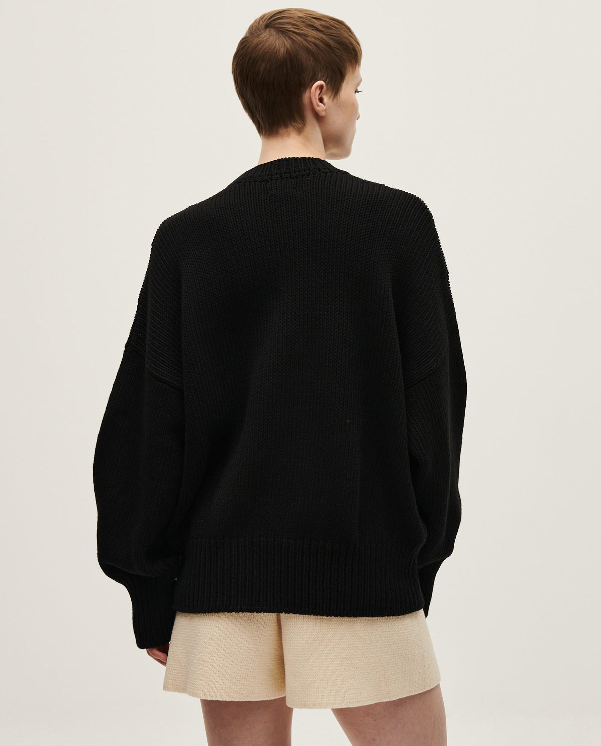Black Babaà Jumper No16 worn by a woman, showcasing a stylish and cozy knit sweater with a relaxed fit.