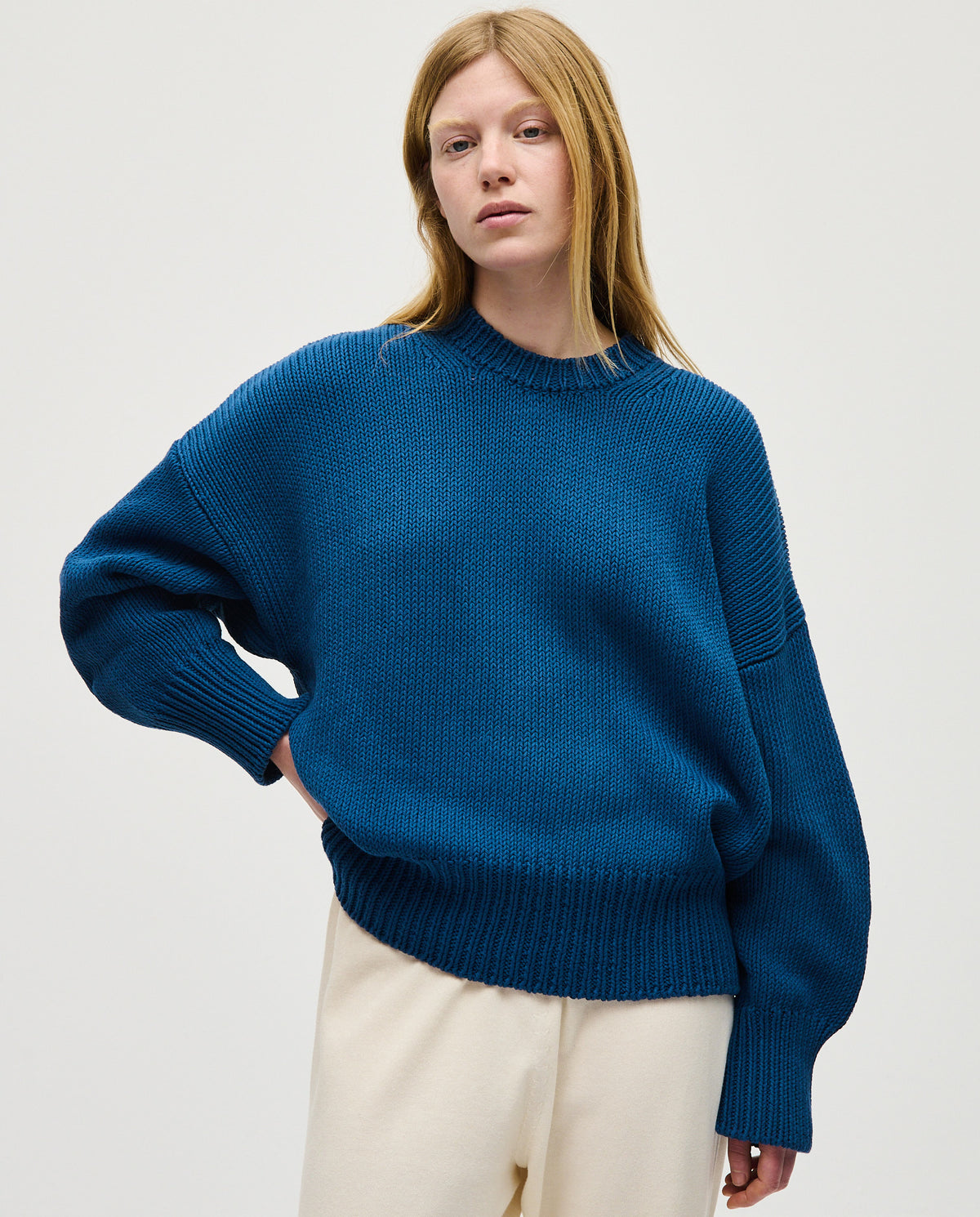 Babaà Jumper No16 Deep Water worn by a woman, featuring a cozy knit design in deep water blue.