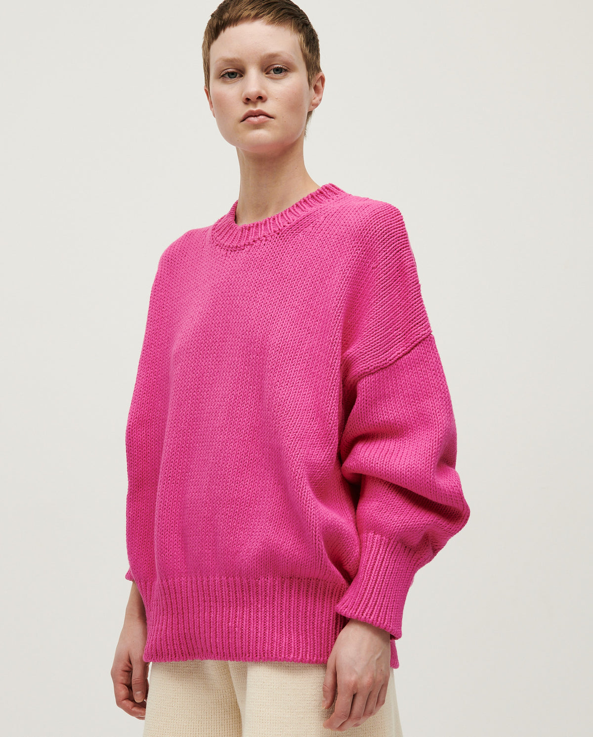 Babaà jumper No16 featuring a vibrant hibiscus flower design worn by a woman, showcasing a stylish and colorful knit sweater.