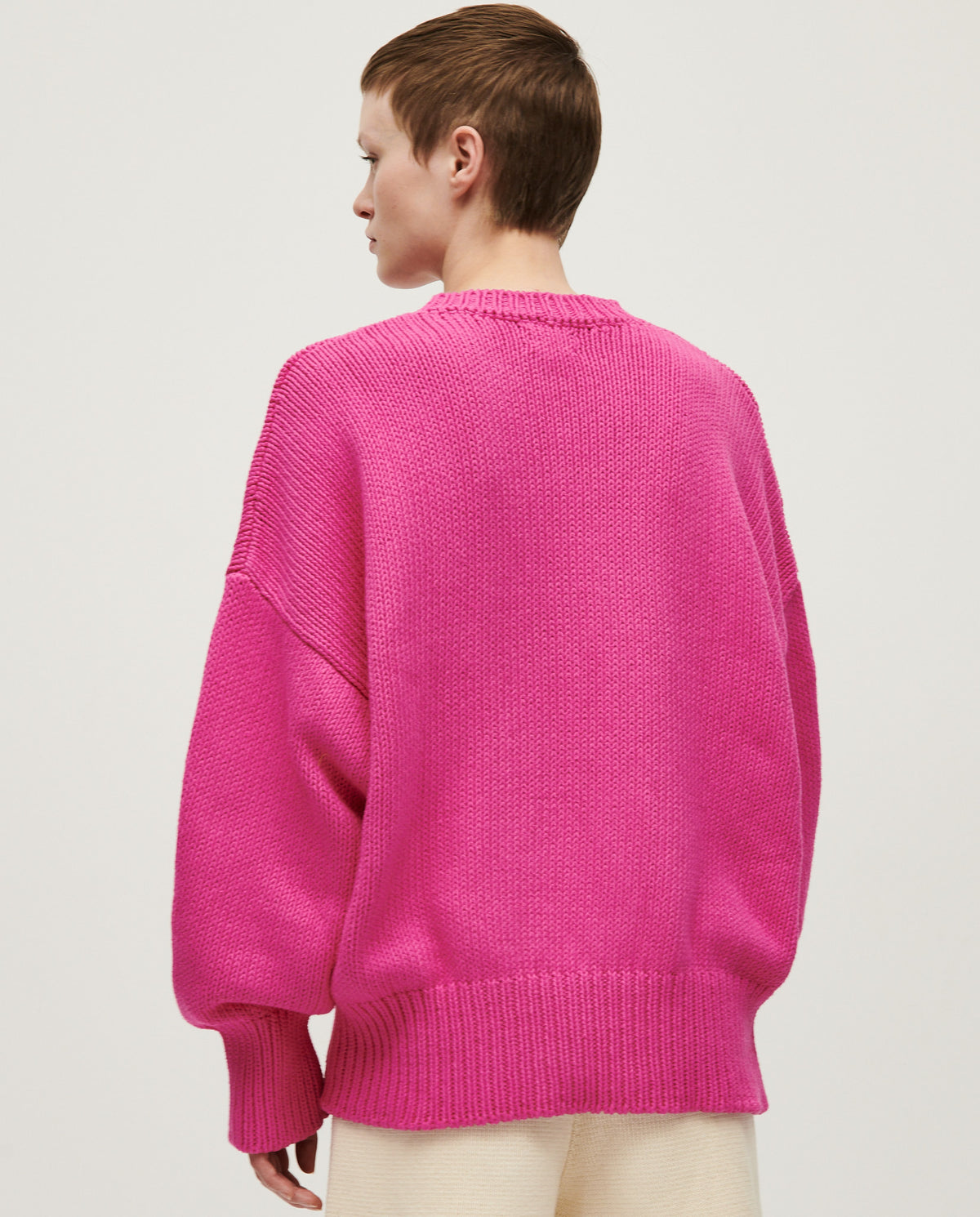 Babaà Jumper No16 with Hibiscus Flower pattern worn by a woman, showcasing a stylish knitted sweater with floral design.