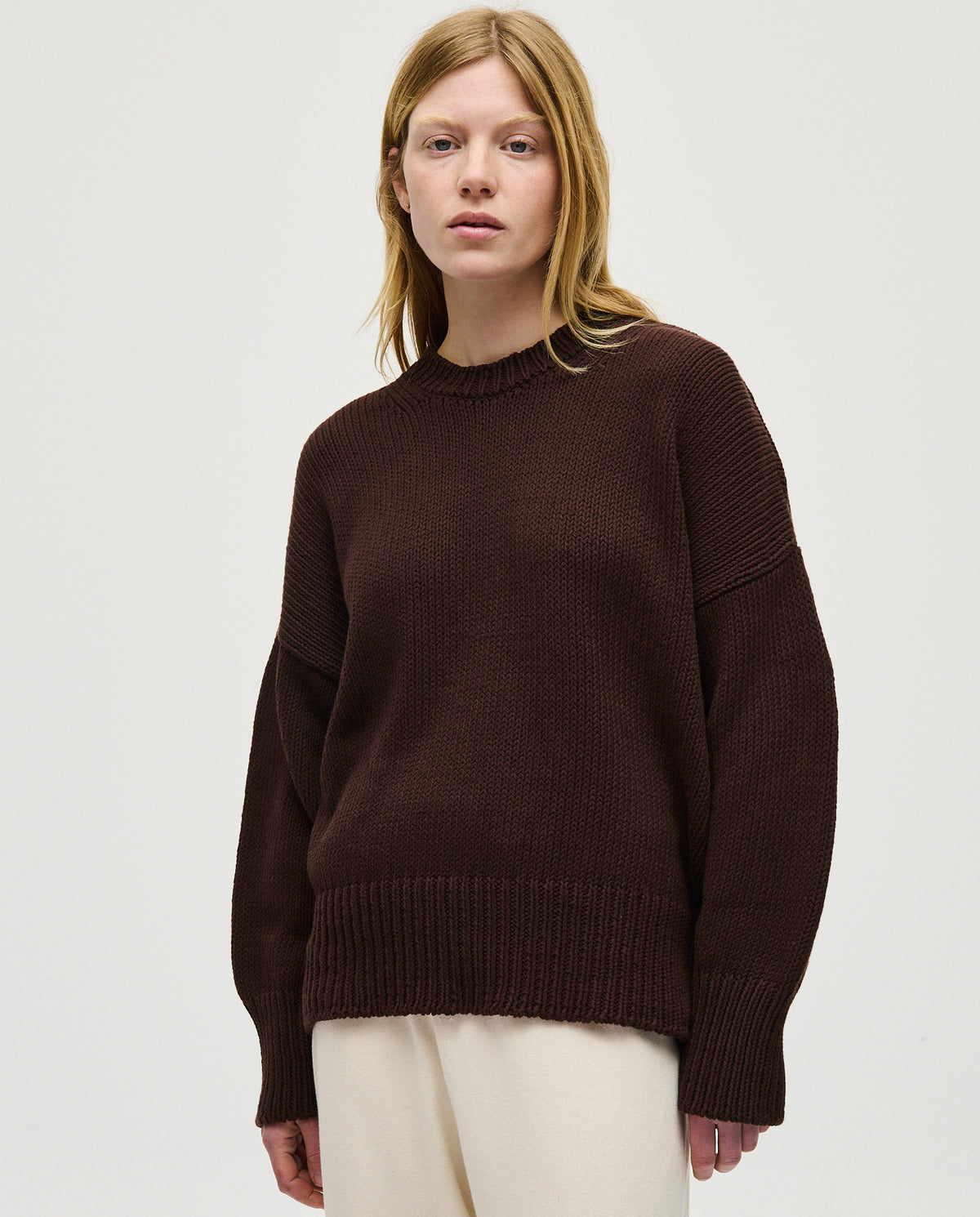 Woman wearing Babaà No16 Husk jumper, soft knit sweater with a relaxed fit, styled for casual comfort.
