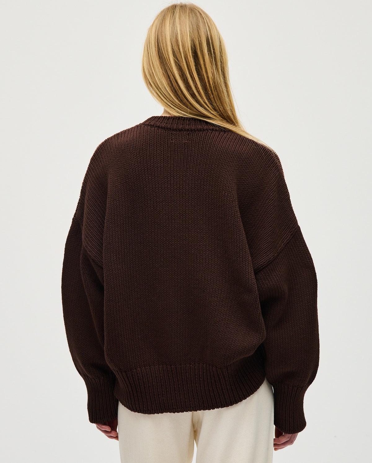 Woman wearing Babaà No16 Husk jumper, soft knit sweater with a relaxed fit, showcasing its cozy, stylish design.