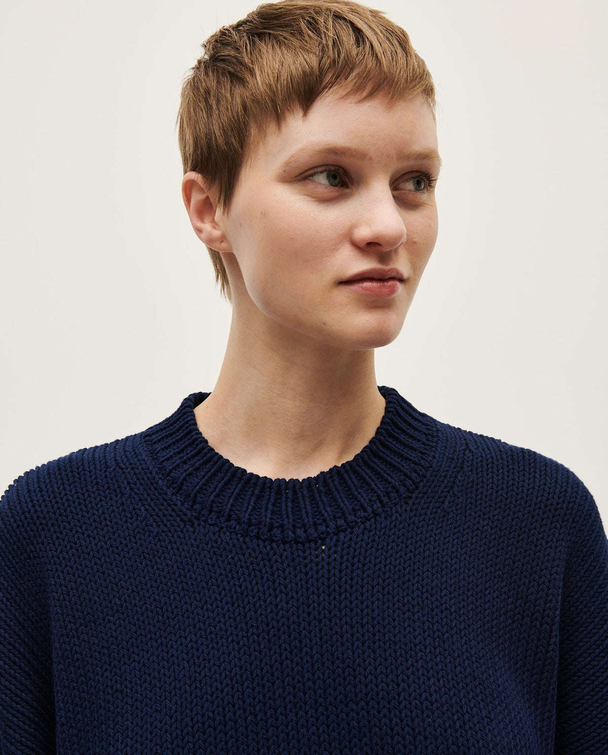 Navy Jumper No16 by Babaà, worn by a woman, showing a cozy knit sweater with a round neckline and long sleeves.