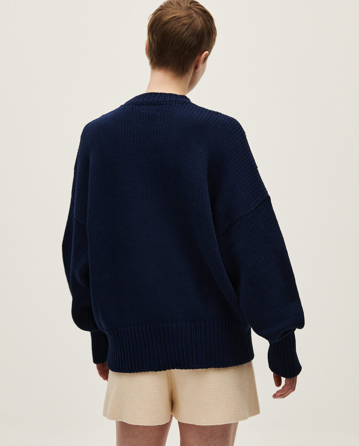 Navy jumper No16 by Babaà, worn by a woman, featuring a cozy fit and classic knit design, perfect for casual wear.