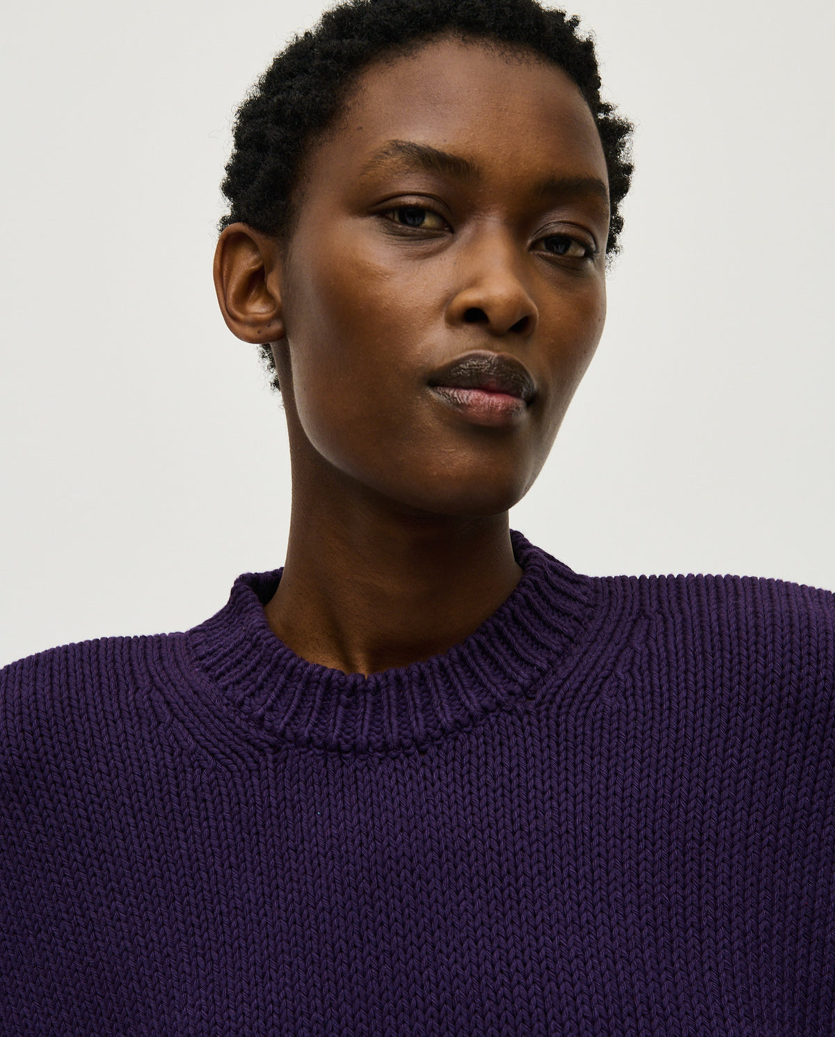 Woman wearing Babaà No16 Ridge jumper, featuring a cozy, textured knit in a relaxed fit, ideal for casual wear.