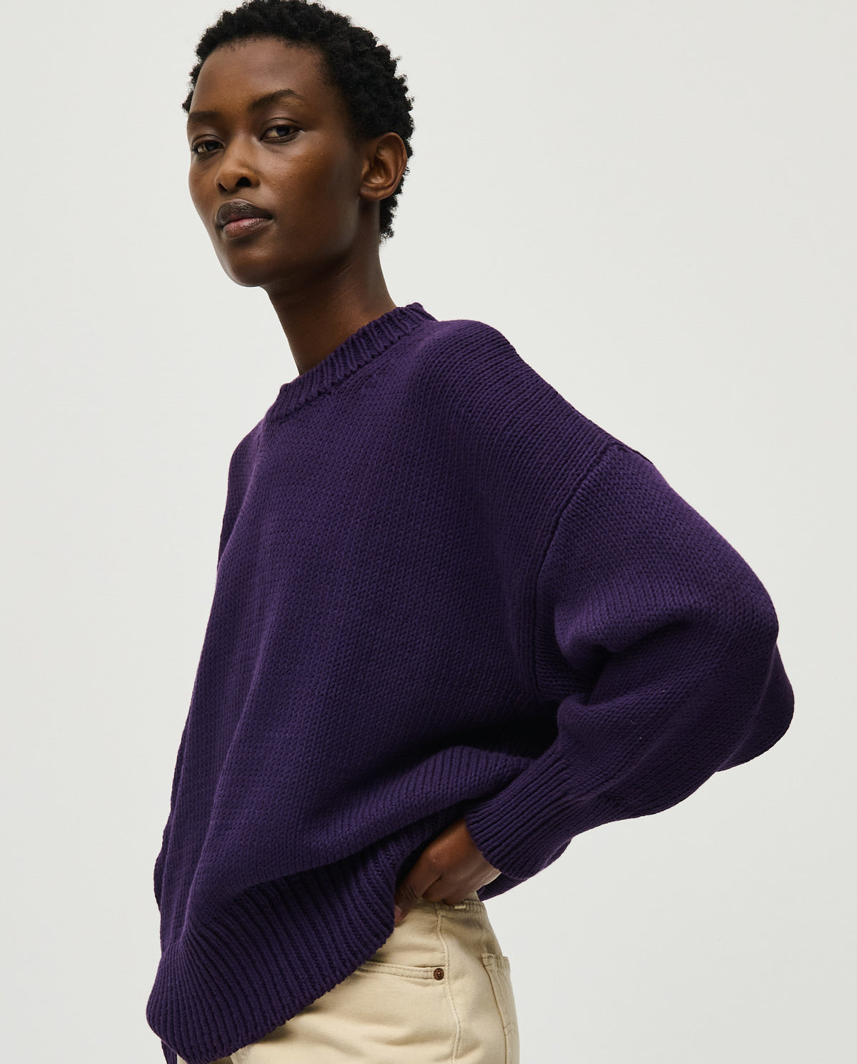Woman wearing Babaà No16 Ridge jumper, showcasing the cozy knit sweater with a high neckline and textured pattern.