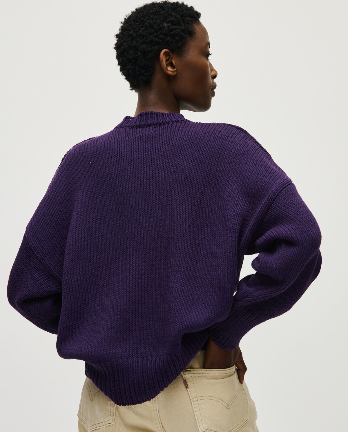 Woman wearing Babaà No16 Ridge jumper, stylish knit sweater with ribbed texture, in a cozy, contemporary design.