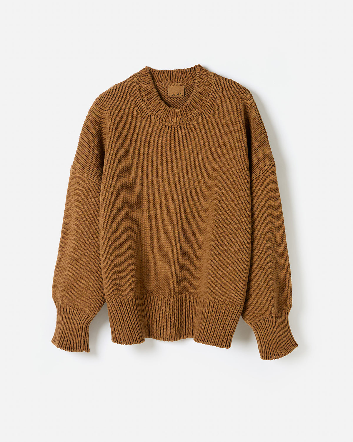 Silhouette of a woman wearing Babaà Jumper No16 Sukkari, showcasing its relaxed fit and cozy knit fabric.