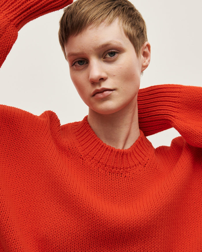 Woman wearing Babaà No16 Summer Flame jumper, featuring a lightweight, stylish knit in vibrant flame-inspired colors.