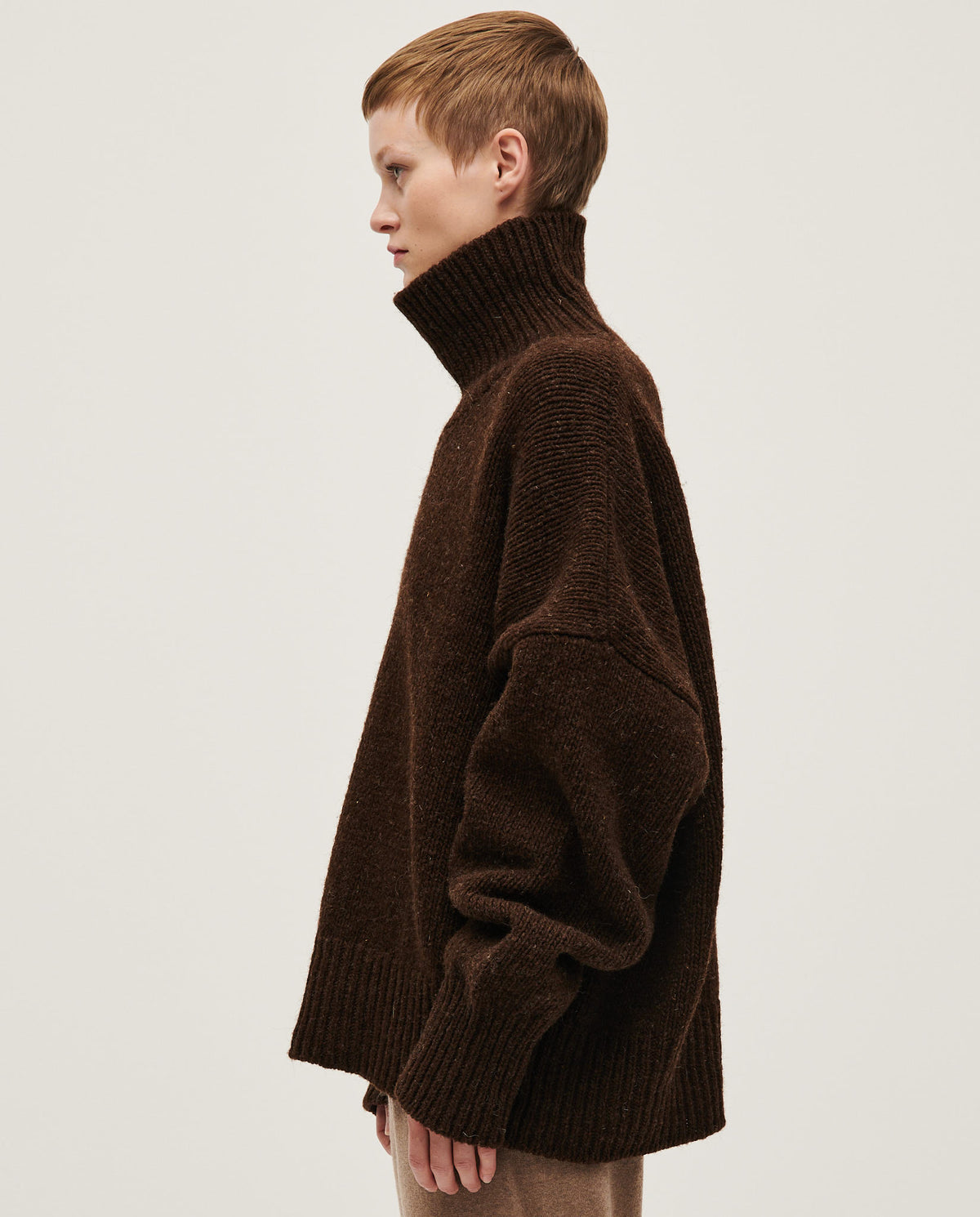Woman wearing Babaà No17 Earth jumper, showcasing its cozy, earthy-toned knit sweater style.