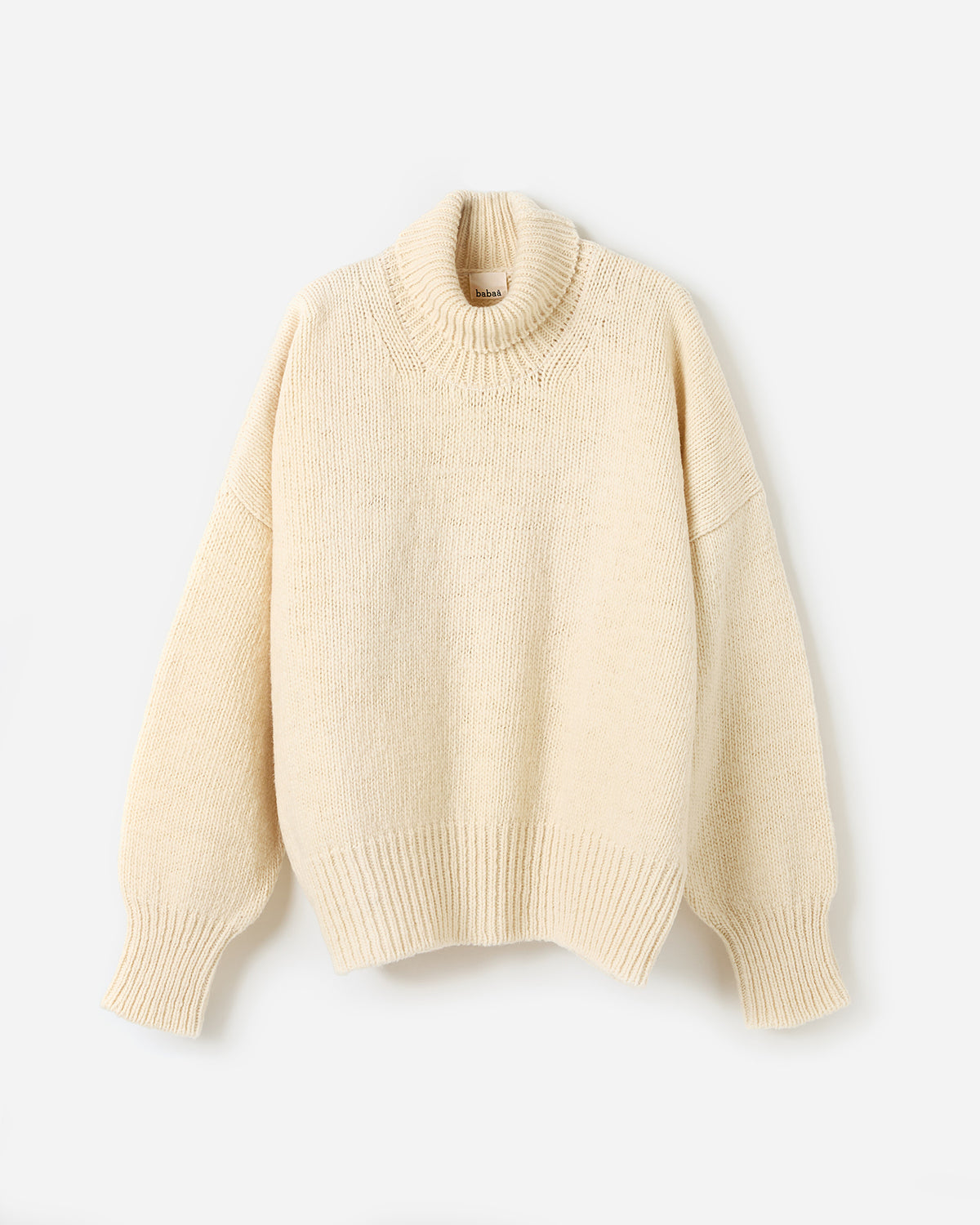 Woman wearing Babaà No17 Natural jumper, showcasing a relaxed fit and soft natural-colored knit in a stylish silhouette.