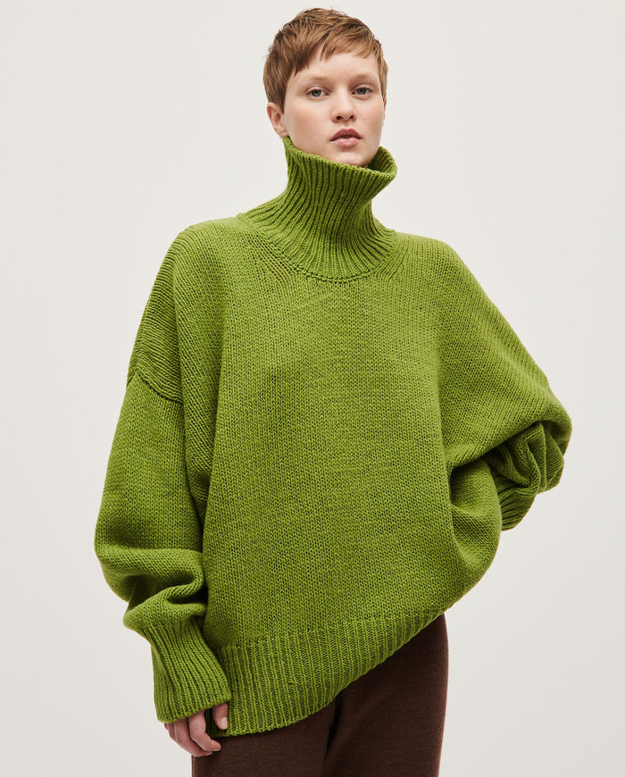 Light beige Babaà No17 Olivera jumper worn by a woman, featuring a cozy knit design and relaxed fit.