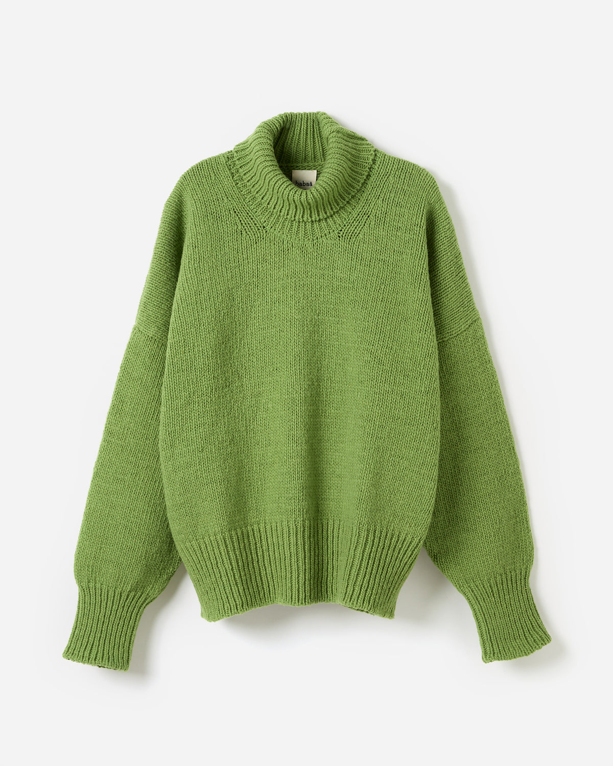Silhouette of a woman wearing the Babaà No17 Olivera jumper, showcasing its relaxed fit and cozy knit fabric.