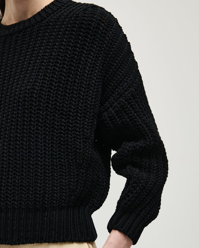 Black Babaà jumper No.18 worn by a woman, featuring a cozy, stylish knit design perfect for casual and chic outfits.