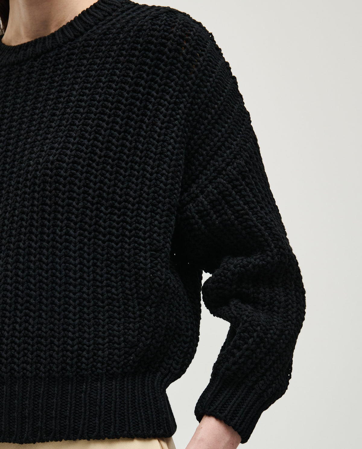 Black Babaà jumper No.18 worn by a woman, featuring a cozy, stylish knit design perfect for casual and chic outfits.