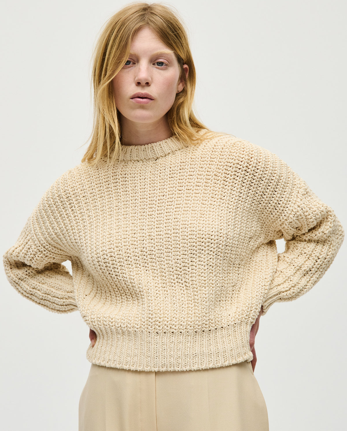 Woman wearing Babaà No18 Natural jumper, soft knit sweater with a relaxed fit, showcasing its cozy and stylish design.