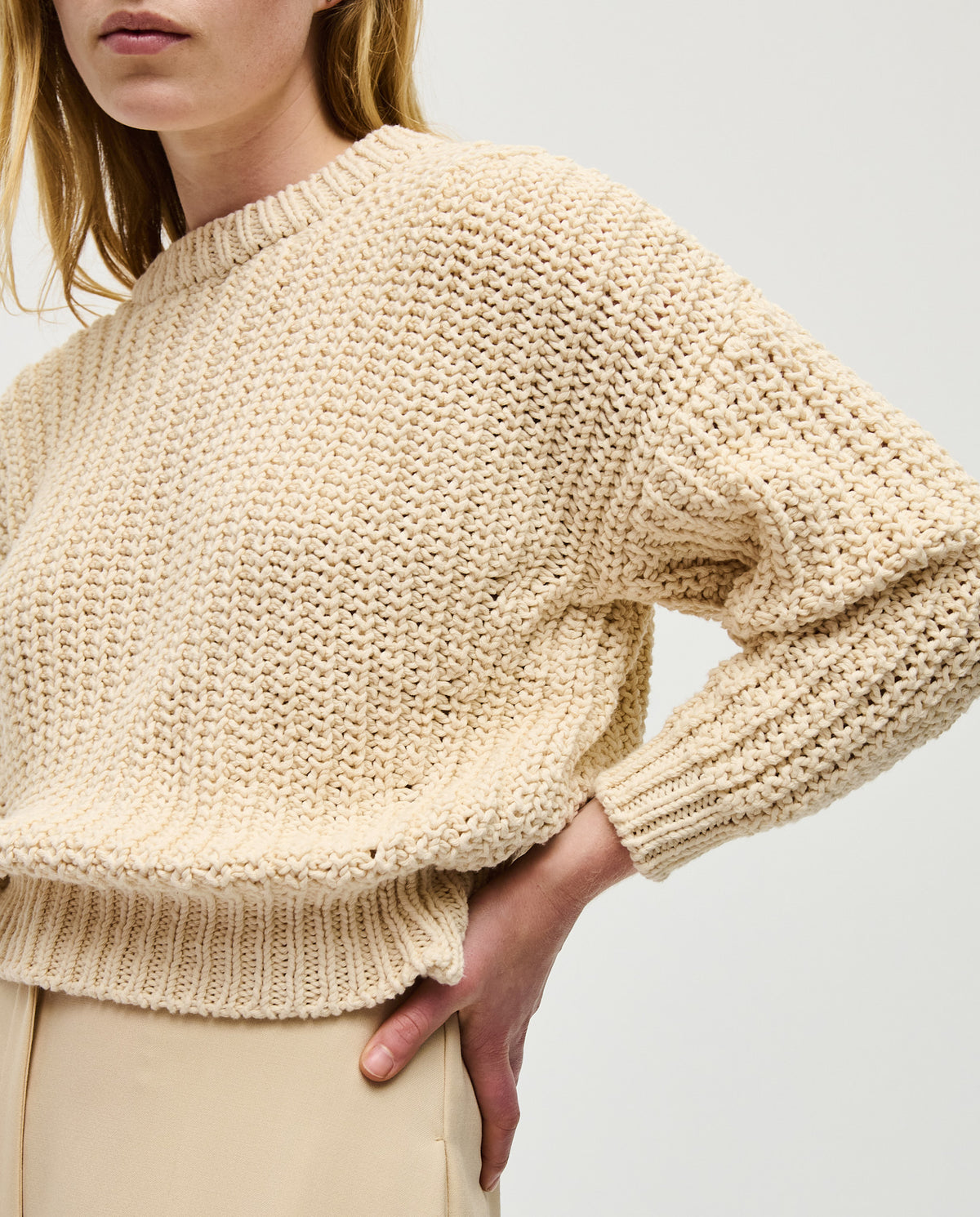 Woman wearing Babaà No18 Natural jumper, showcasing the cozy knit sweater in a relaxed fit with neutral tones.