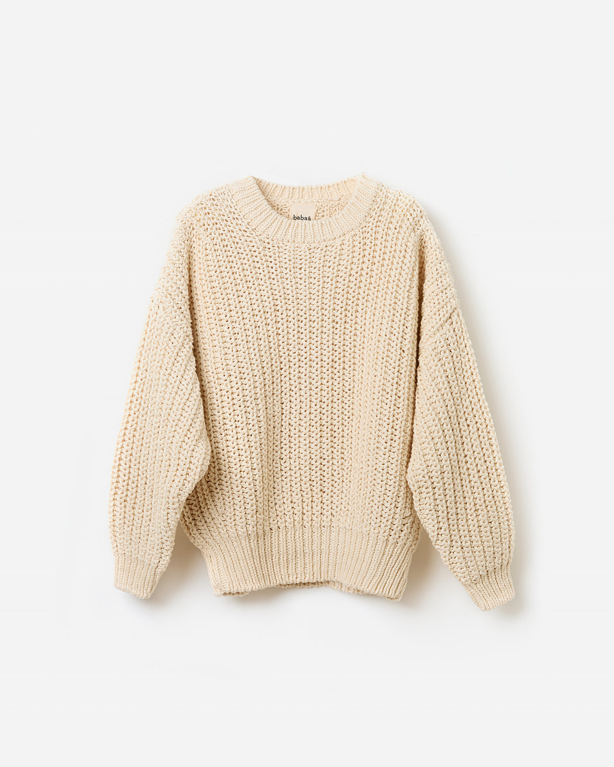 Woman wearing Babaà No18 natural jumper, showcasing the relaxed fit and soft fabric in a side silhouette view.