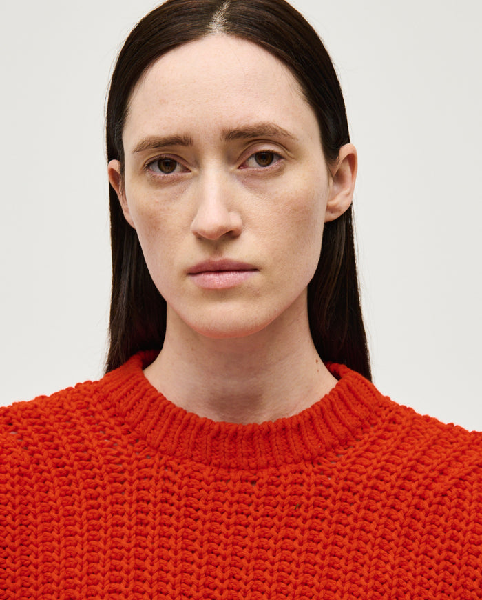 Woman wearing Babaà Jumper No18 Summer Flame, lightweight knitted jumper with vibrant flame pattern, perfect for warm weather.