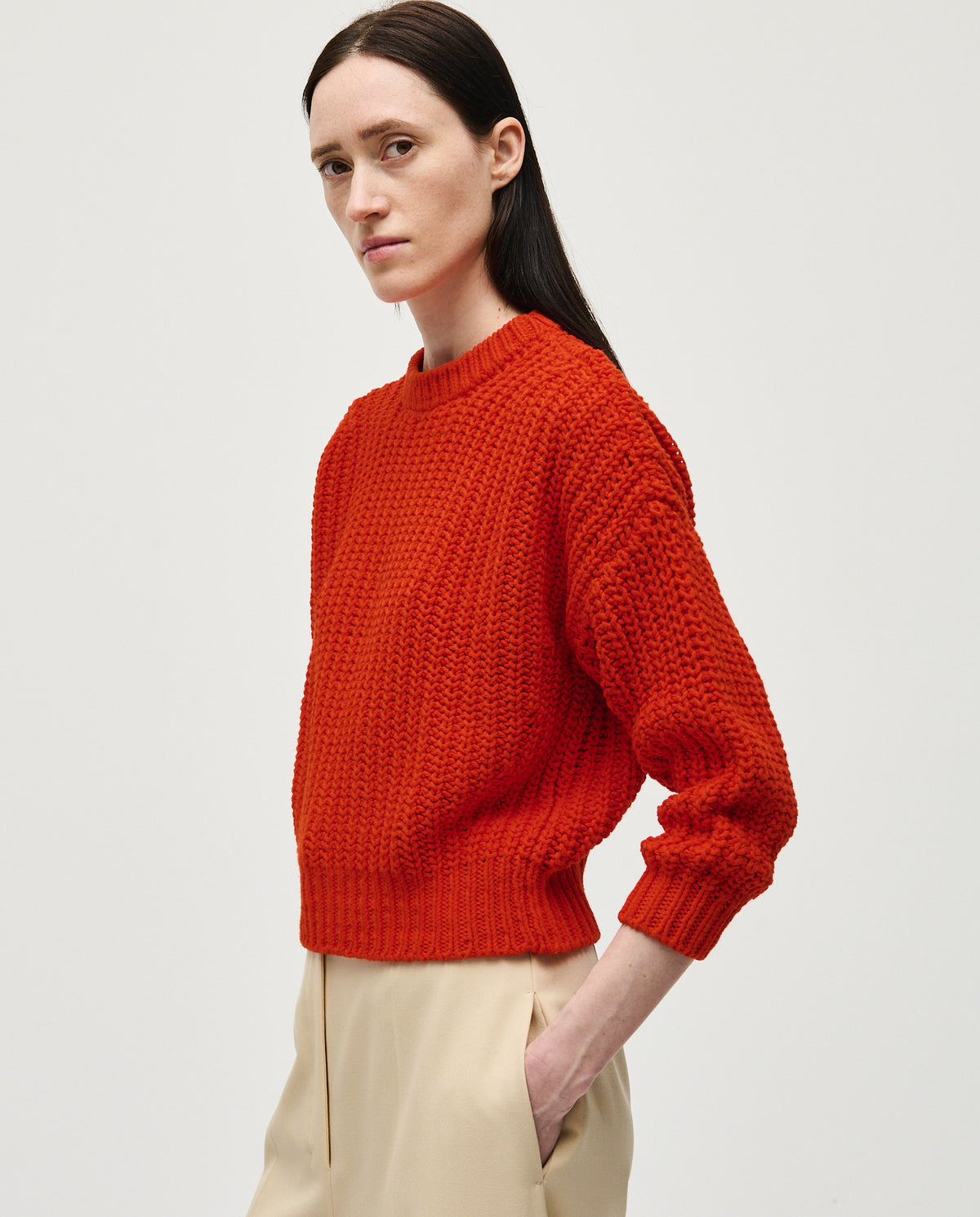 Woman wearing Babaà Jumper No18 Summer Flame, lightweight knit sweater in vibrant flame orange, casual and stylish for summer.