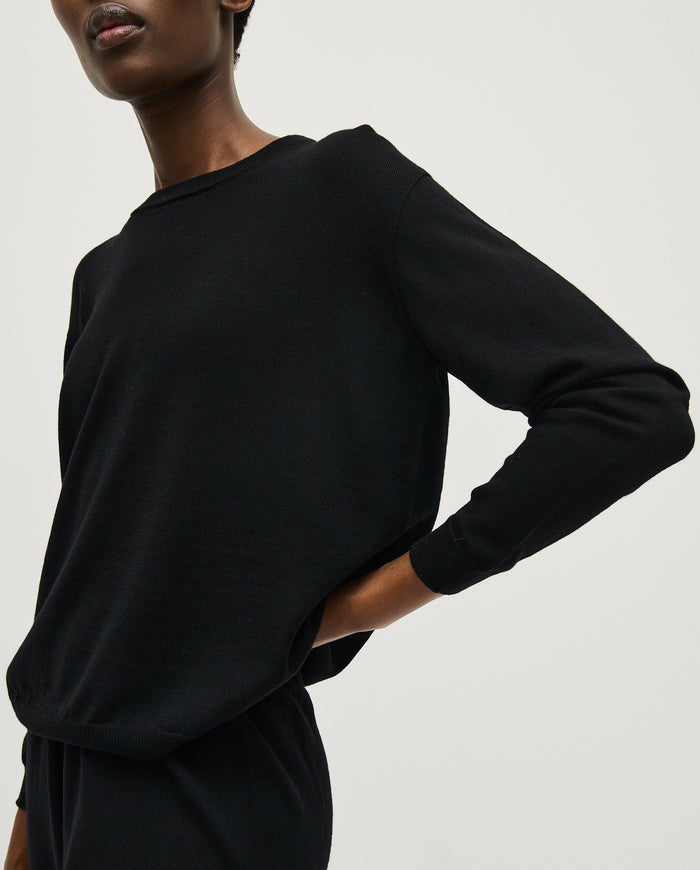 Black Babaà No25 women's jumper displayed on a woman, featuring a cozy, stylish knit design for casual wear.