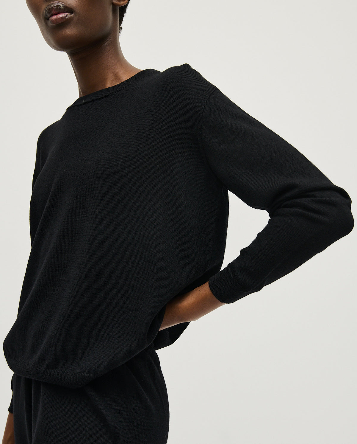 Black Babaà No25 women's jumper displayed on a woman, featuring a cozy, stylish knit design for casual wear.
