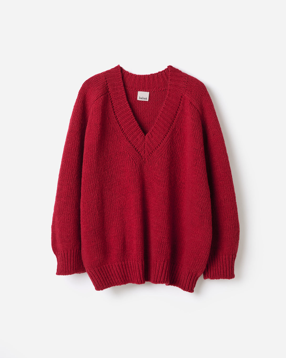 Silhouette of a woman wearing a Babaà No29 Cereza jumper, showcasing its relaxed fit and stylish design on a plain background.