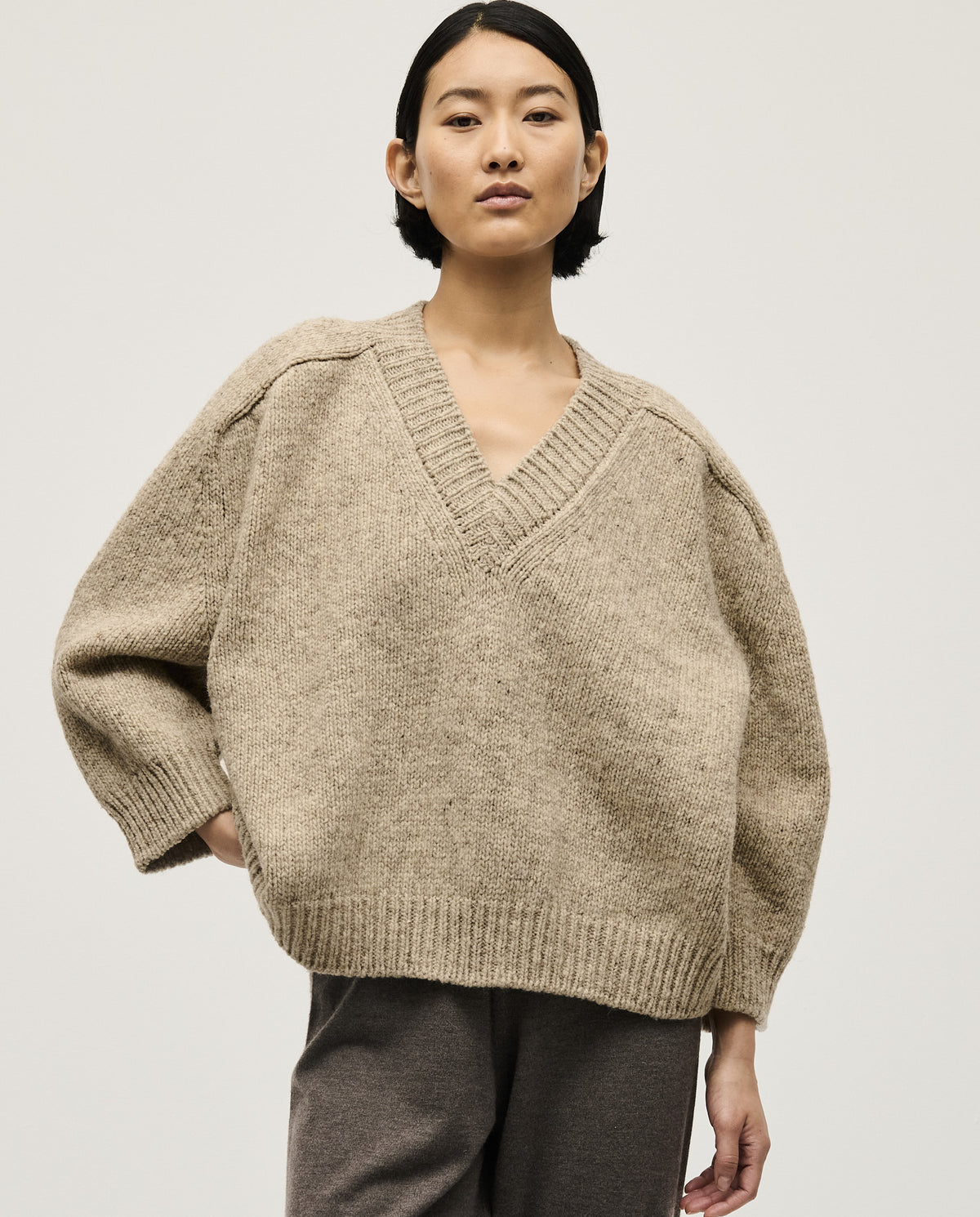 Light gray Babaà No29 Mist jumper worn by a woman, showcasing a cozy, stylish knit sweater with a relaxed fit.
