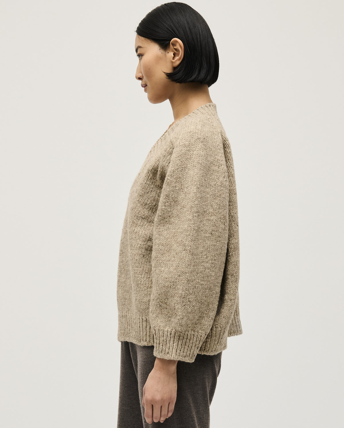 Woman wearing Babaà No29 Mist jumper, featuring a cozy, soft knit with a relaxed fit in a stylish mist color.