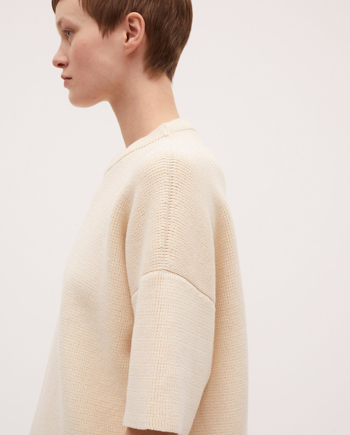 Woman wearing Babaà No35 natural jumper, soft beige knit sweater with a relaxed fit and cozy style.