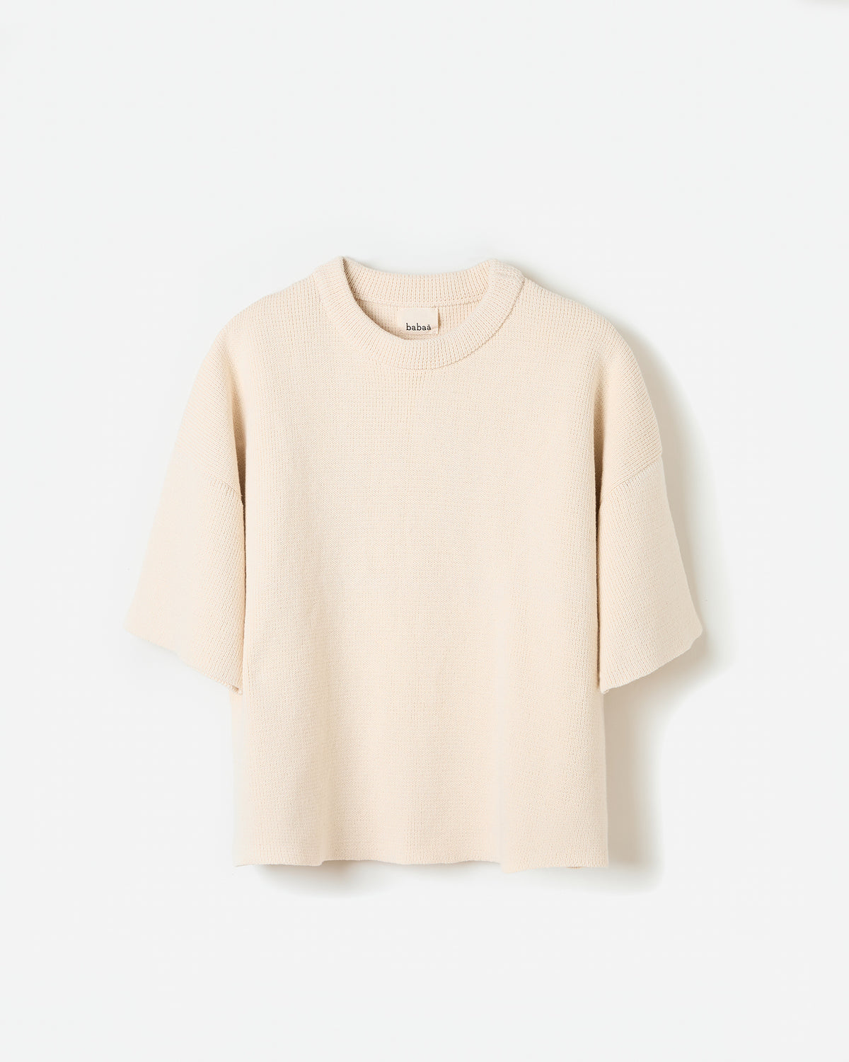 Woman wearing Babaà No35 Natural jumper, showcasing the relaxed silhouette and soft fabric in a casual setting.
