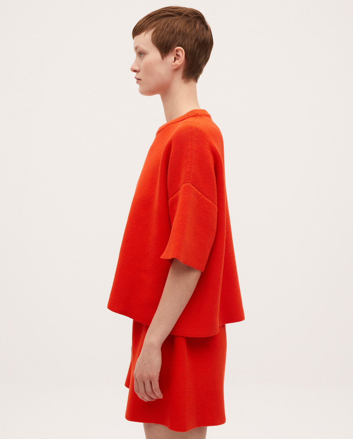 Babaà No35 Tangelo women's jumper, vibrant orange knit sweater worn by a woman, casual and cozy style.
