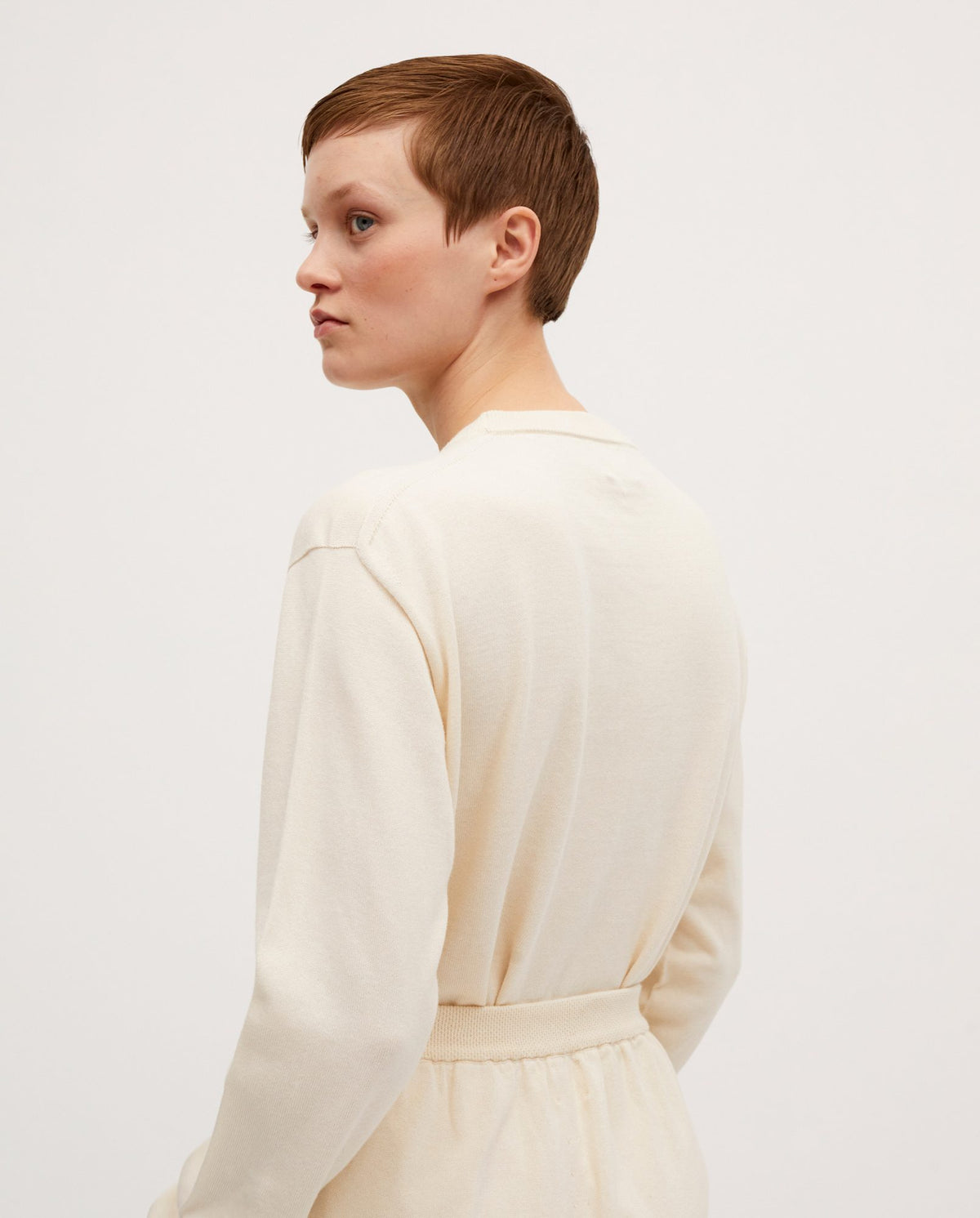 Babaà No37 natural women's jumper displayed on a woman, featuring a cozy, neutral-colored knit sweater with long sleeves.