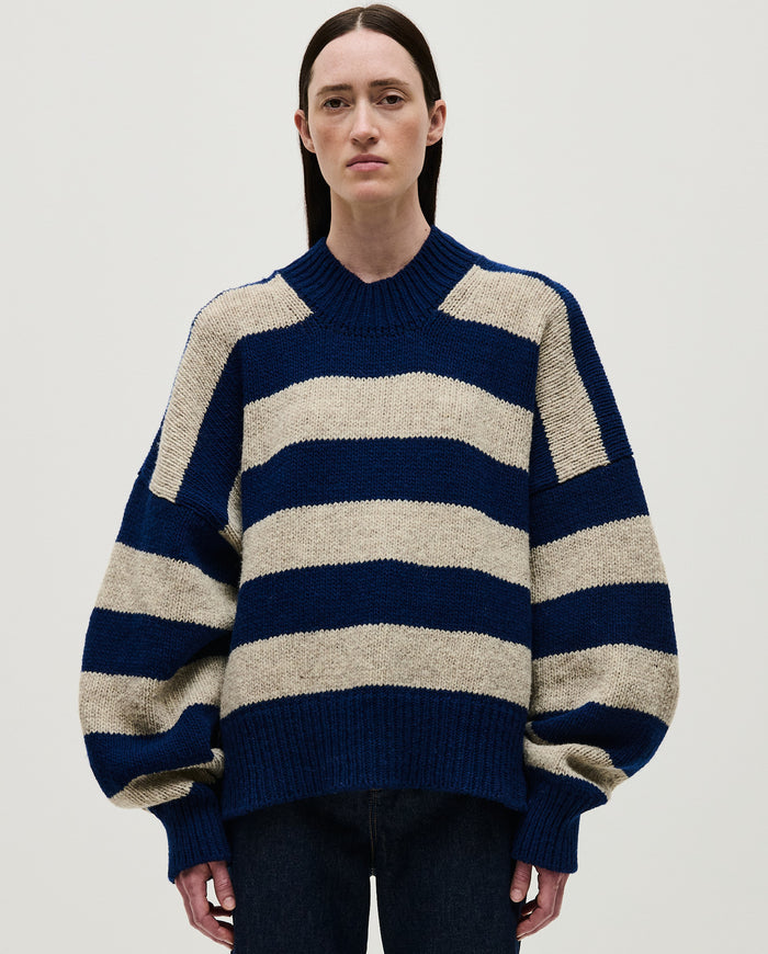 Woman wearing Babaà No40 Marino jumper, cozy navy knit sweater styled casually, close-up view of the soft fabric and fit.