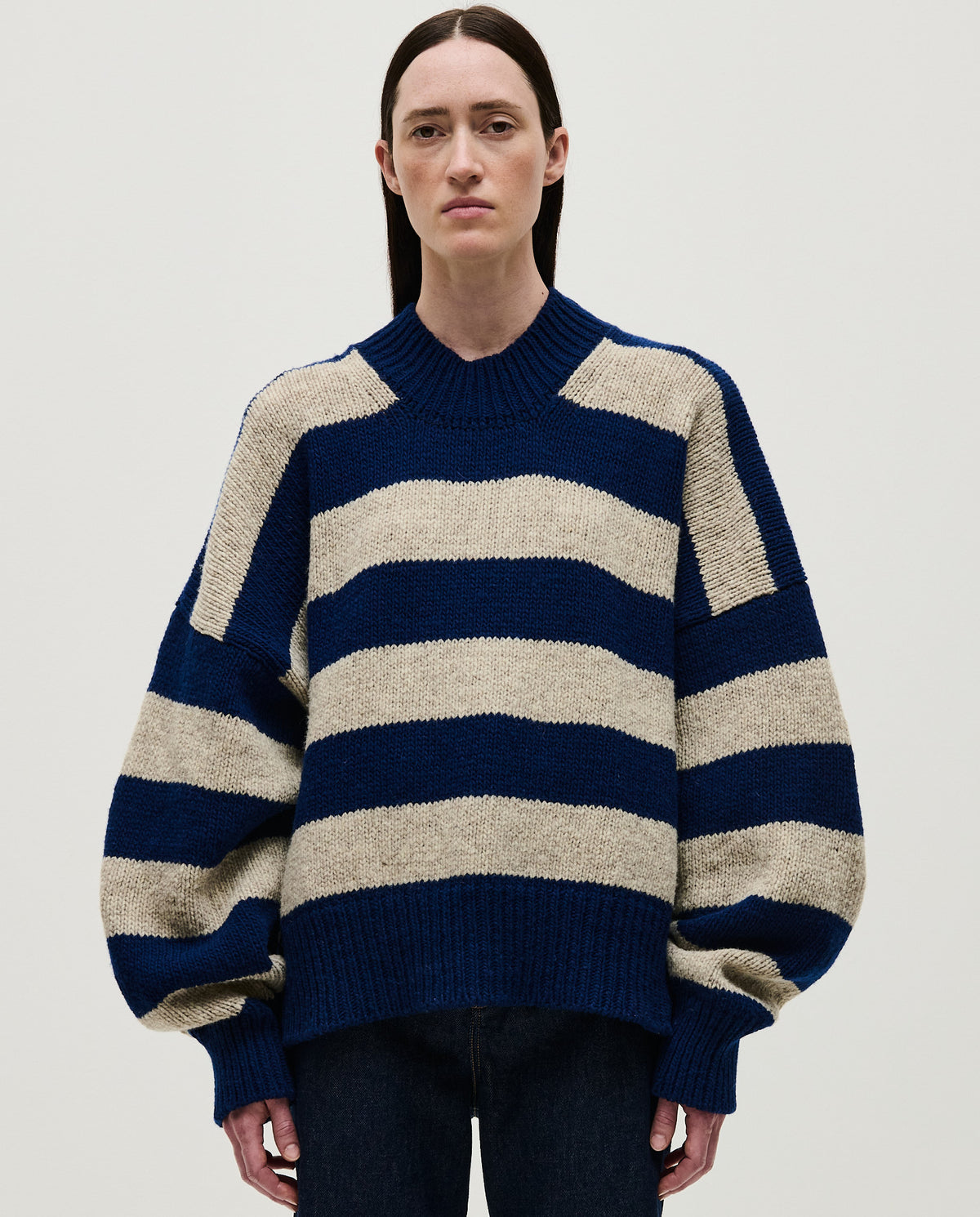 Woman wearing Babaà No40 Marino jumper, cozy navy knit sweater styled casually, close-up view of the soft fabric and fit.