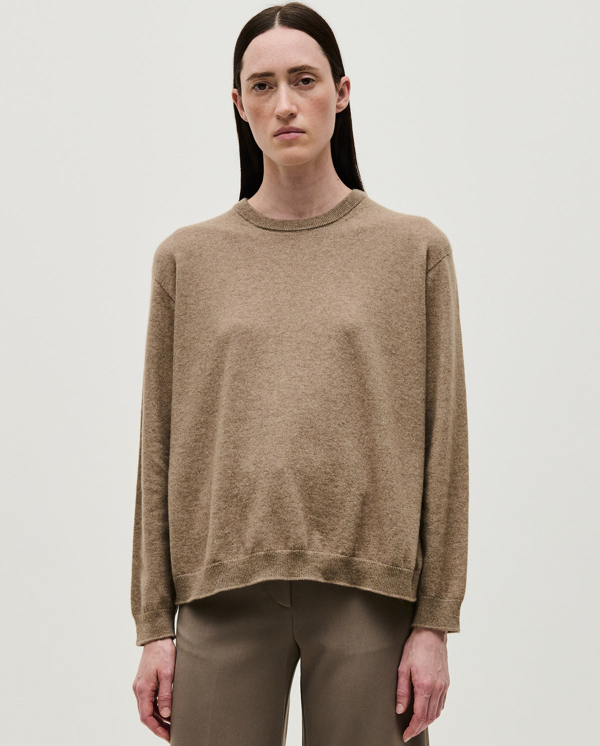 Woman wearing Babaà No41 limestone jumper, showcasing the cozy knit sweater in a soft limestone color.