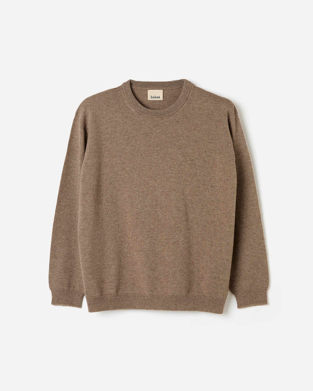 Woman wearing Babaà No41 Limestone jumper, showcasing the silhouette and relaxed fit of the stylish knit sweater.
