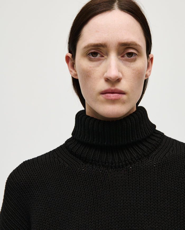 Black Babaà No42 women's jumper displayed on a woman, showcasing a cozy, stylish knit sweater.