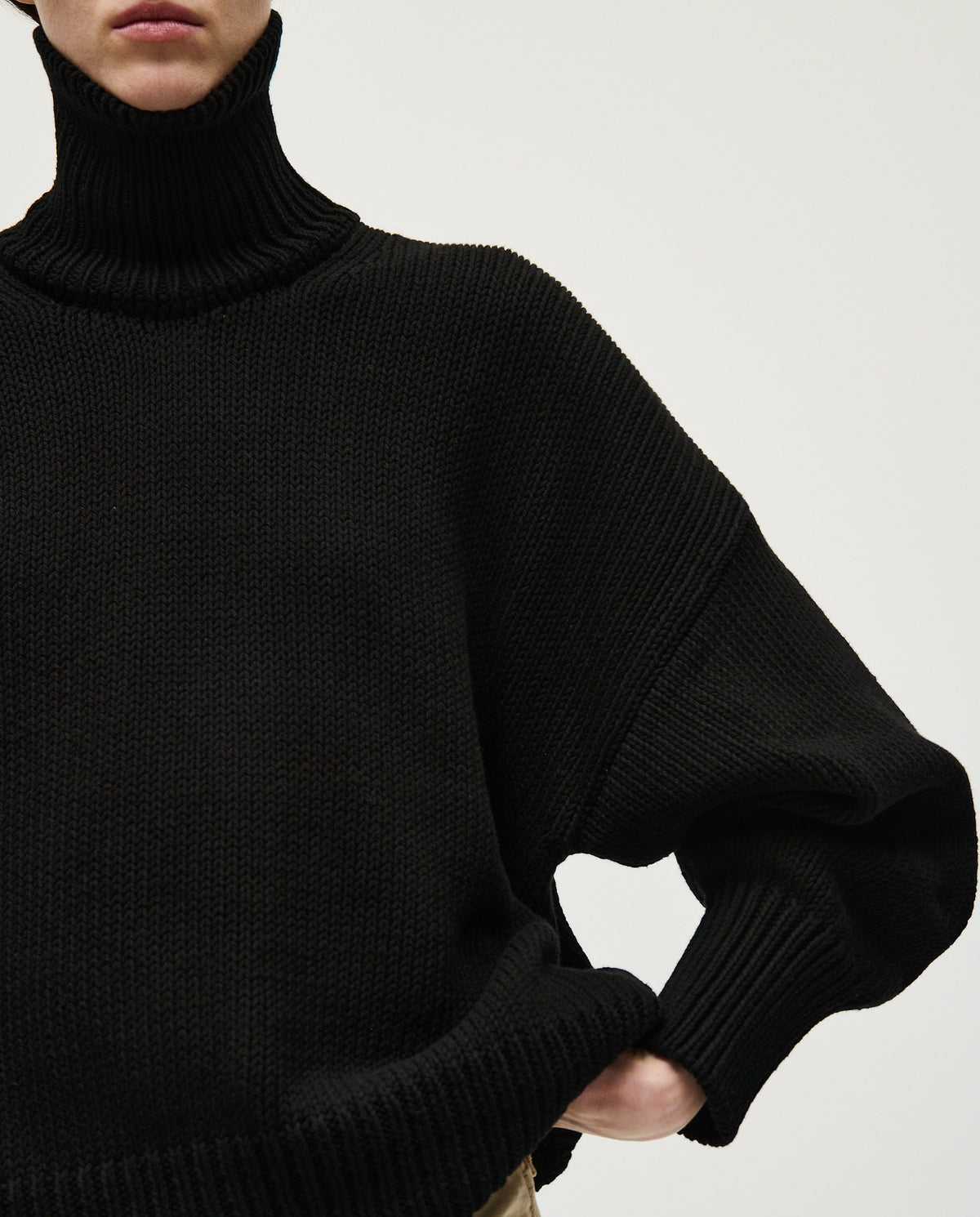 Black Babaà jumper No42 worn by a woman, showcasing a cozy, stylish knit sweater with a relaxed fit and soft fabric.