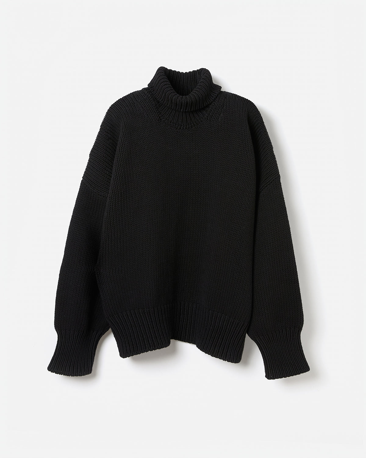 Black Babaà jumper No42 worn by a woman, showcasing a stylish, fitted silhouette against a neutral background.