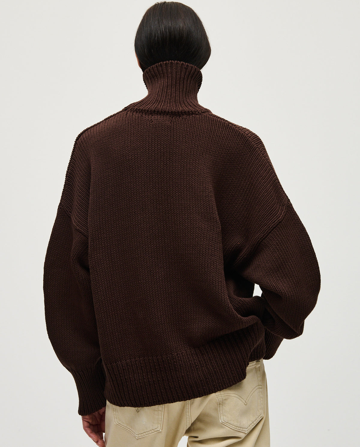 Woman wearing Babaà No42 Husk jumper, cozy knit sweater with a relaxed fit and neutral tones, suitable for casual wear.