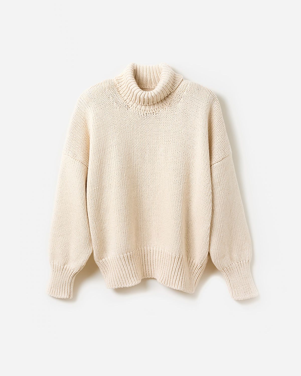 Woman wearing Babaà No42 natural jumper, showcasing a relaxed fit and soft fabric in a side silhouette against a plain background.