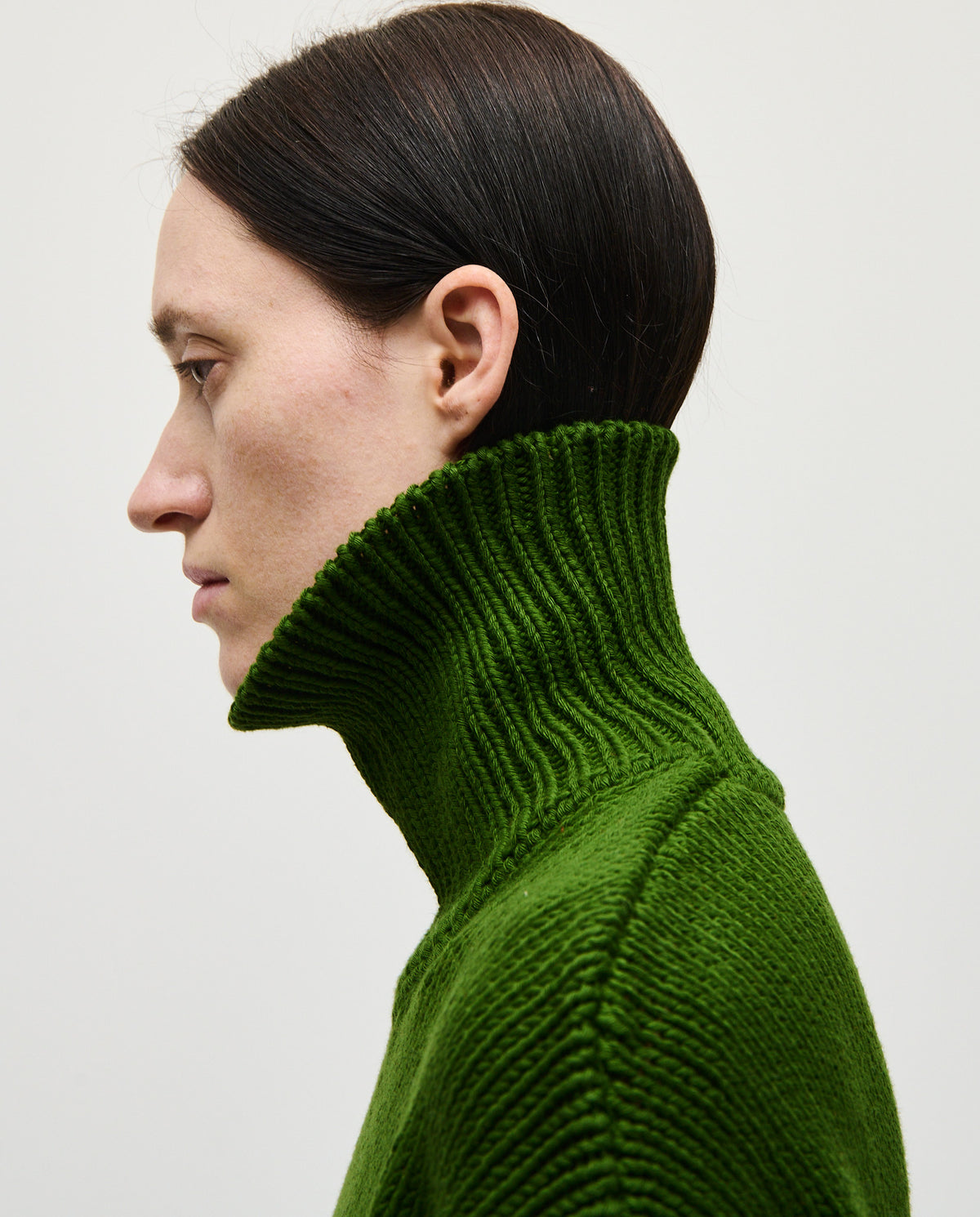 Woman wearing Babaà No42 Pine jumper, showcasing the cozy knit sweater in soft pine green with a relaxed fit.