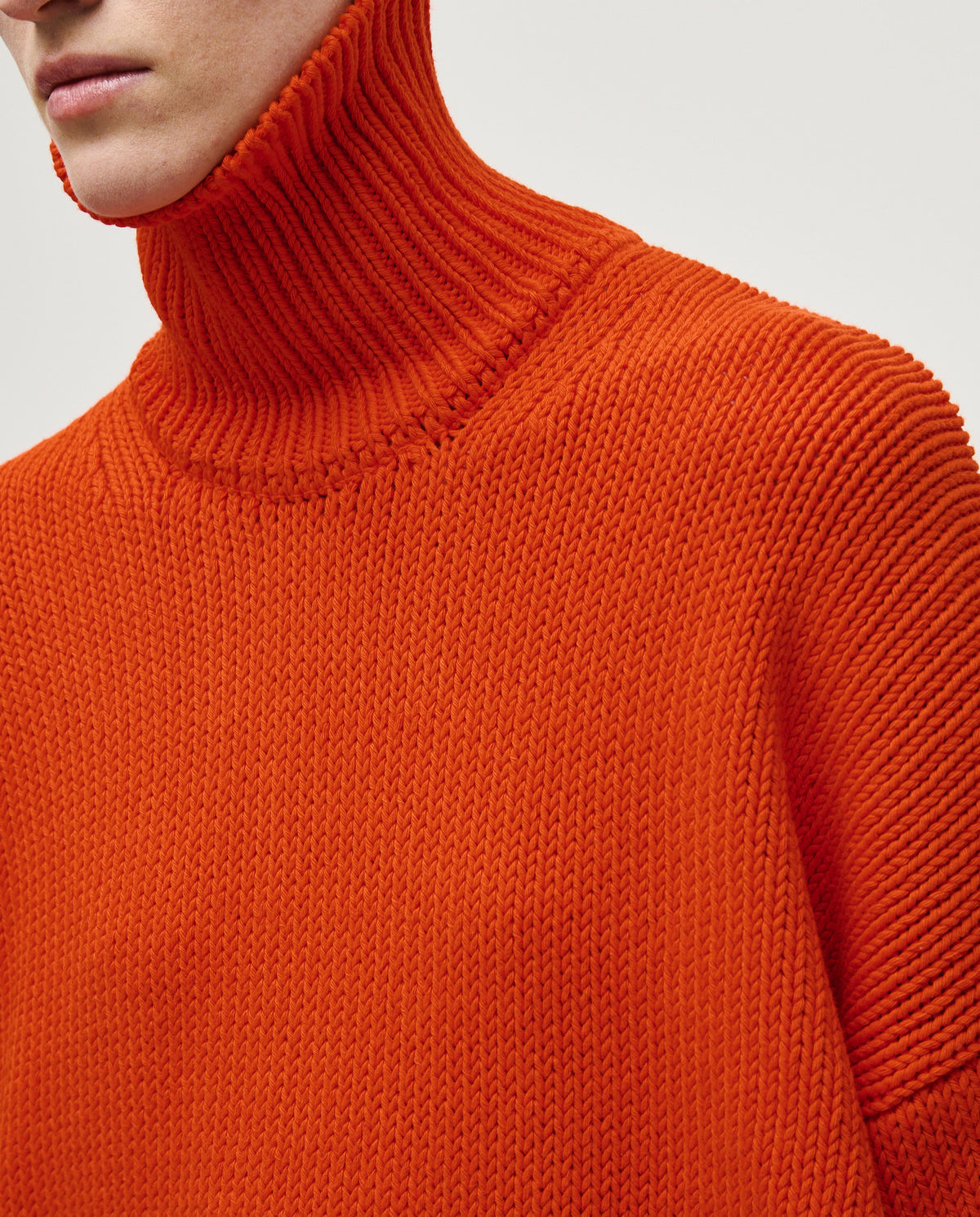 Woman wearing Babaà No42 Summer Flame jumper, featuring a vibrant flame pattern and lightweight knit for warm-weather style.