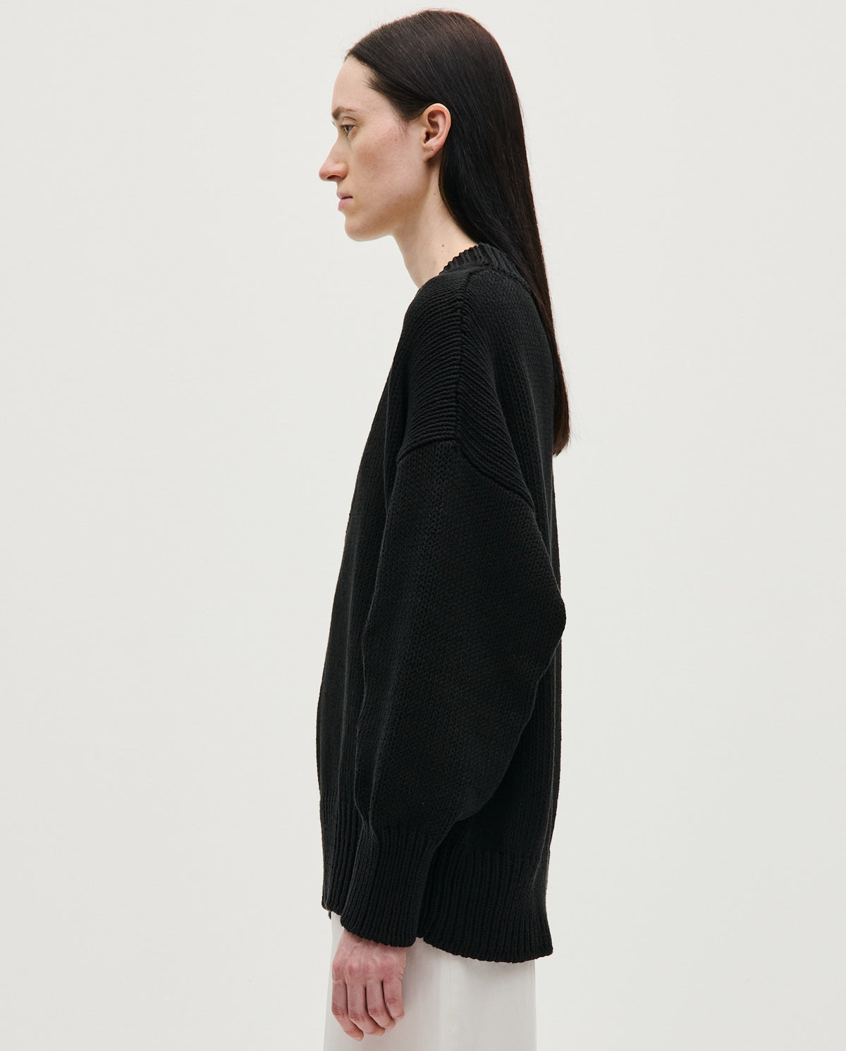 Black Babaà jumper No44 worn by a woman, featuring a cozy, stylish knit design with a high neckline and long sleeves.