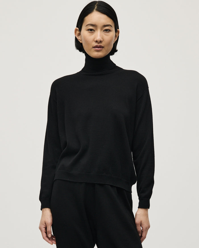 Black Babaà No47 women's jumper displayed on a model, showcasing its cozy fit and stylish design.