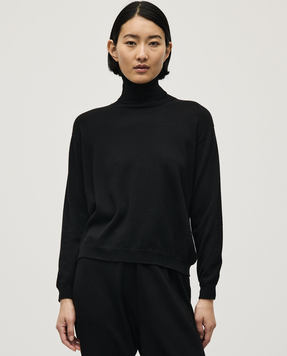 Black Babaà No47 women's jumper displayed on a model, showcasing its cozy fit and stylish design.